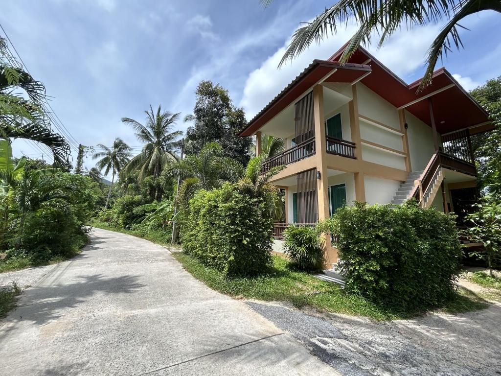 a house on the side of a road at Mina House in Baan Tai