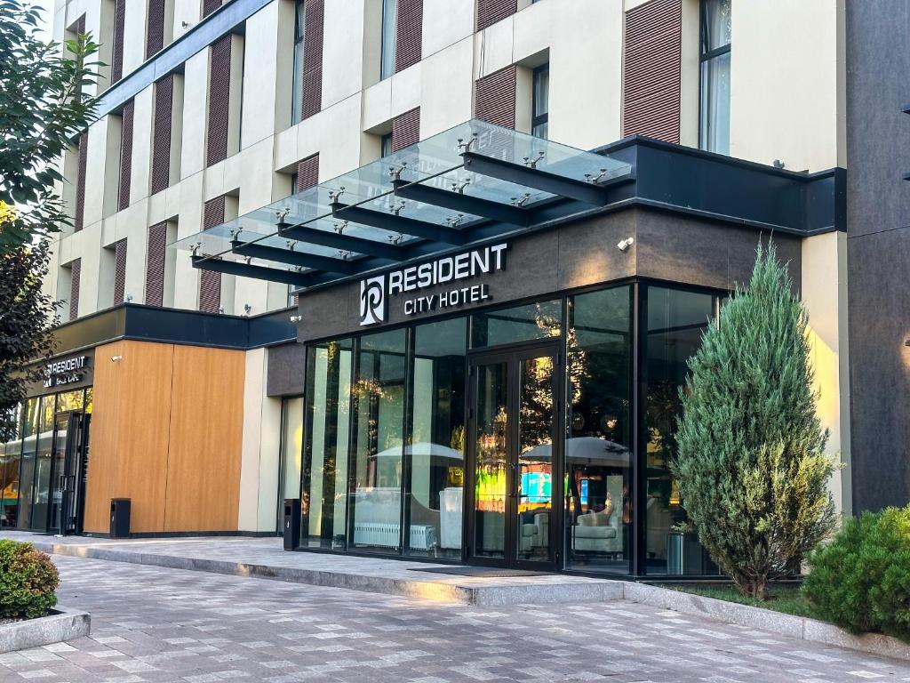 a storefront of a building with a sign for a restaurant at Resident City Hotel in Almaty