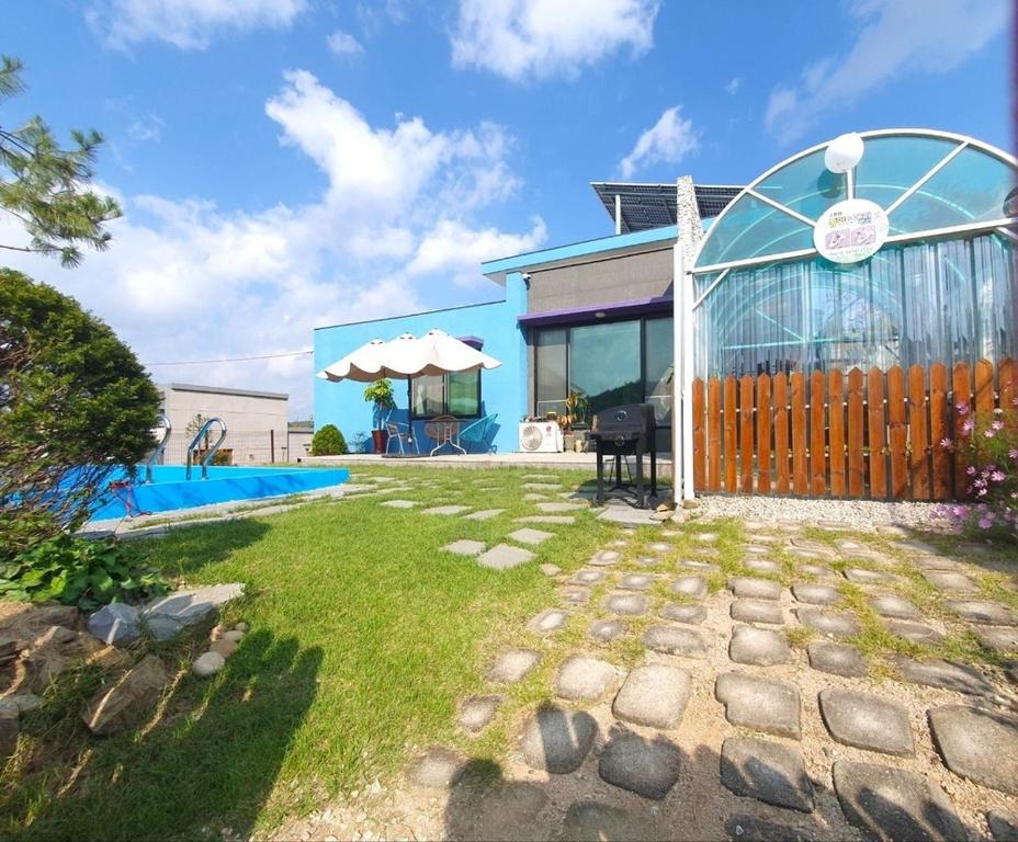 a house with a fence and a yard at Yeoncheon Jjongi and Mary Pet Friendly Pension in Yeoncheon