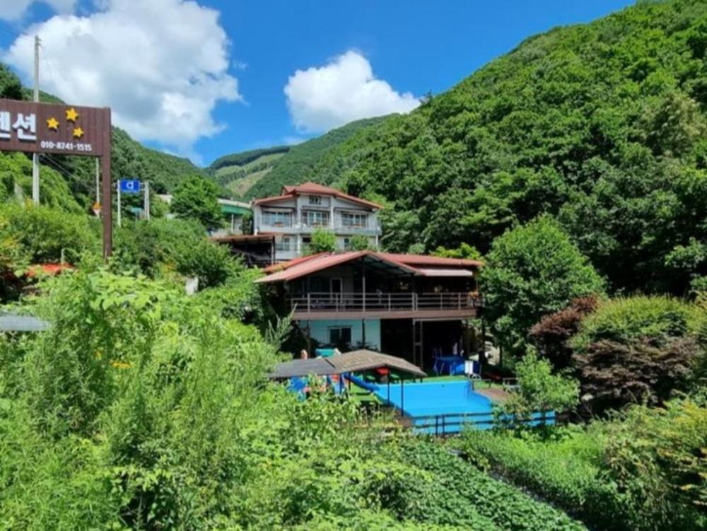 a resort with a mountain in the background at Hwacheon Myeongjiryeong Valley Pension in Hwacheon