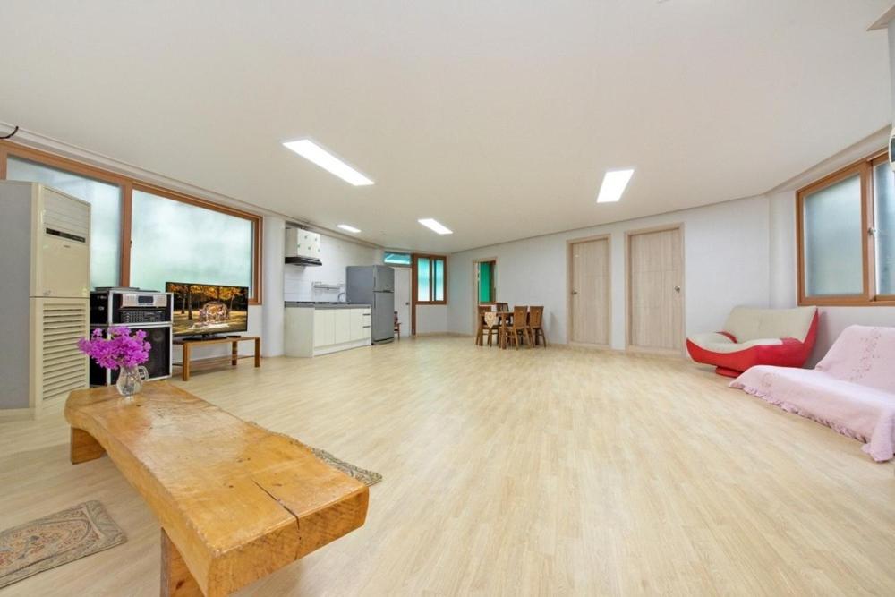 a large living room with a couch and a table at Gapyeong Gangbyeonmaru Pension in Gapyeong