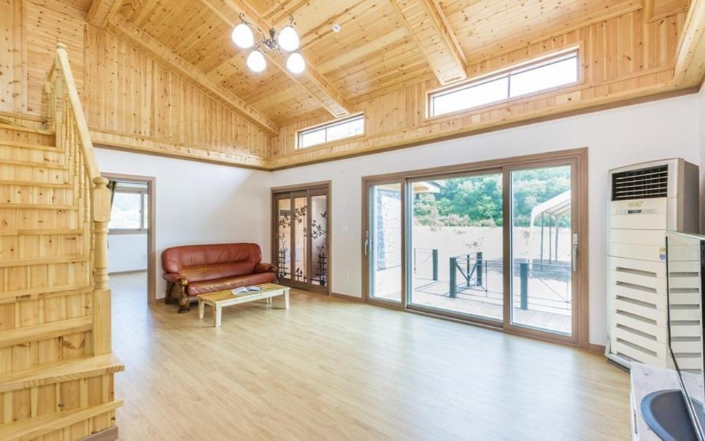 a living room with a couch and a table at Hongcheon Oz Pension in Hongcheon