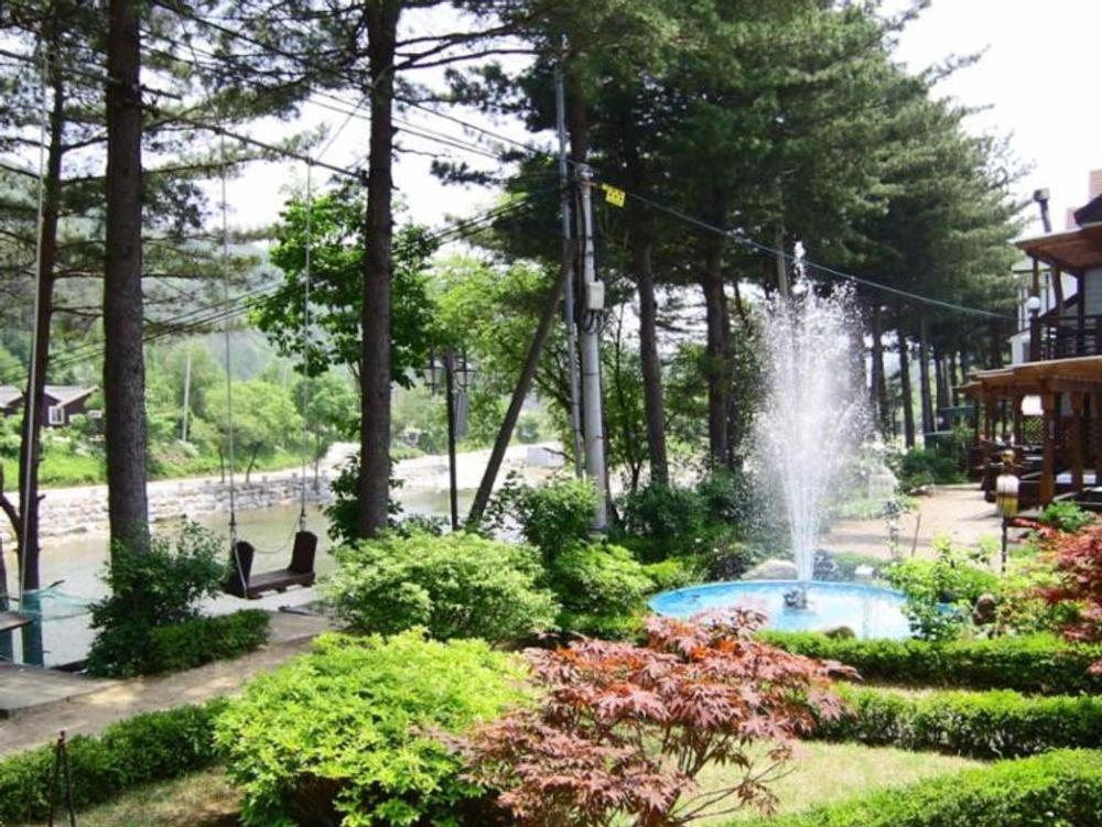 a fountain in the middle of a garden at Eoullim Pension - Moonlight Yard in Pyeongchang 