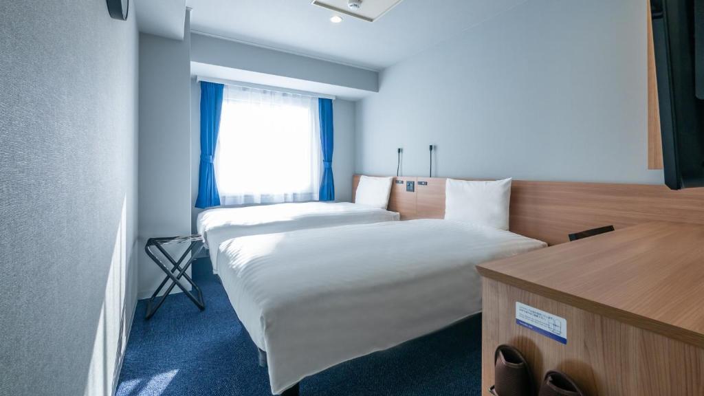 Postel nebo postele na pokoji v ubytování Toyoko Inn Osaka Yodoyabashi-eki Minami