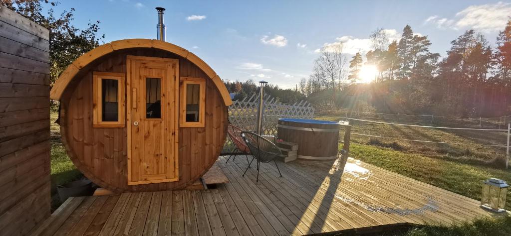 a wooden cabin with a wooden door on a deck at Villa Valentina in Lemland