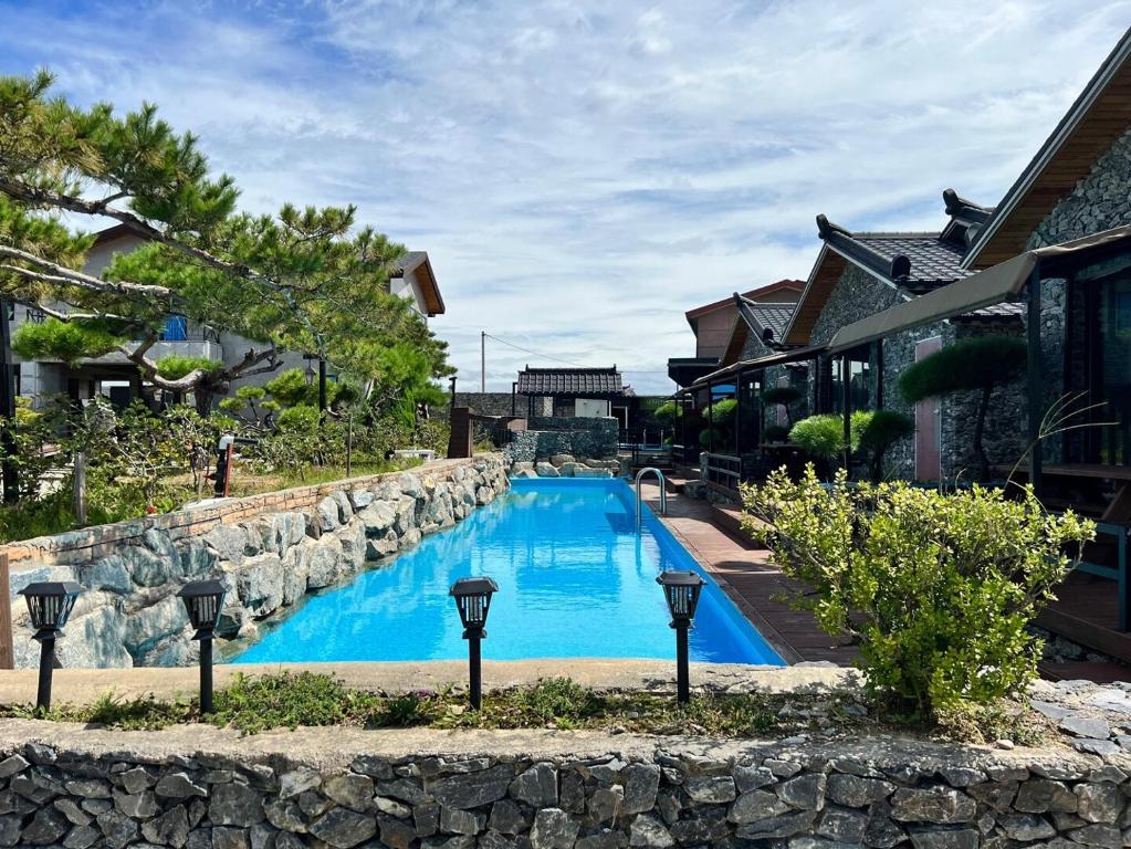a swimming pool in front of a house at Nonsan Oyeo Poolvilla in Nonsan
