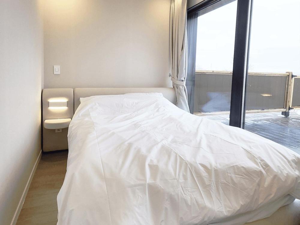 Postel nebo postele na pokoji v ubytování Ganghwa Do N Do Stay