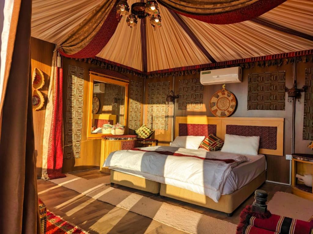 a bedroom with a bed in a tent at Wadi Rum Majestic Camp in Wadi Rum