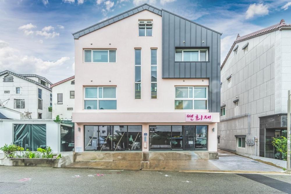 an apartment building with a pink sign on it at Yeonhuijae Pool Villa Private Beomeo Branch in Yangsan