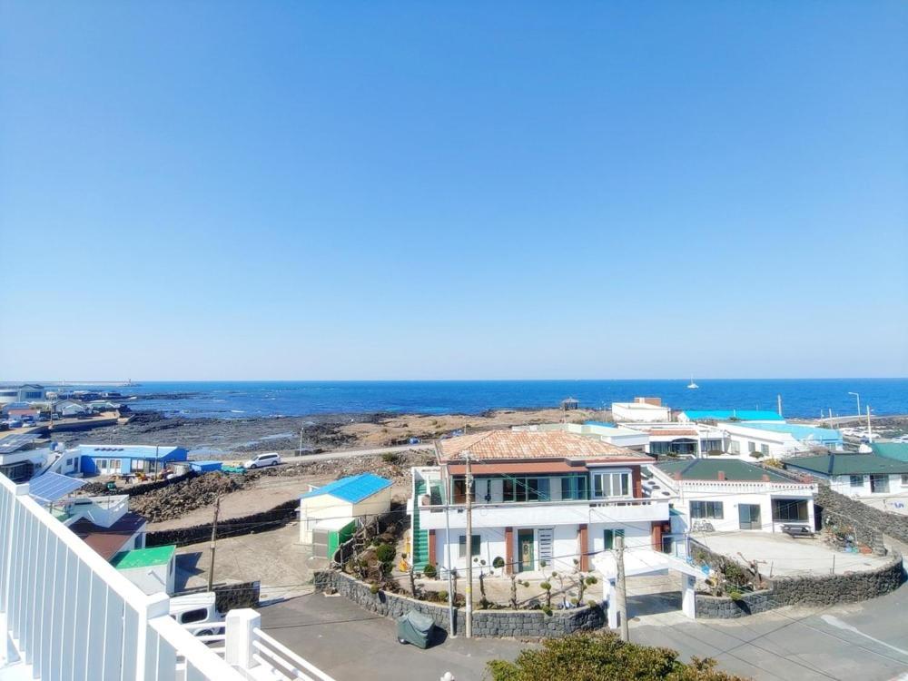 a view of the ocean from the balcony of a house at Jeju Viento Gimnyeong Pension in Jeju