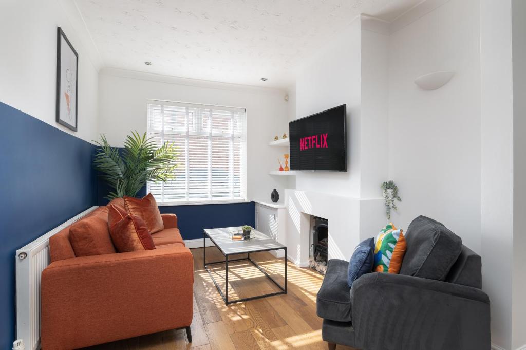 a living room with two chairs and a fireplace at Spacious & Charming 2BR - Perfect Stay in Northampton