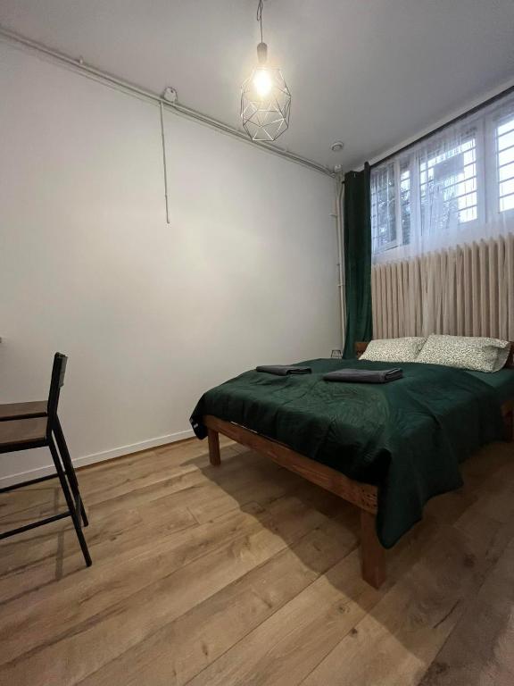 a bedroom with a bed and a chair in it at TomTom Hostel in Krakow