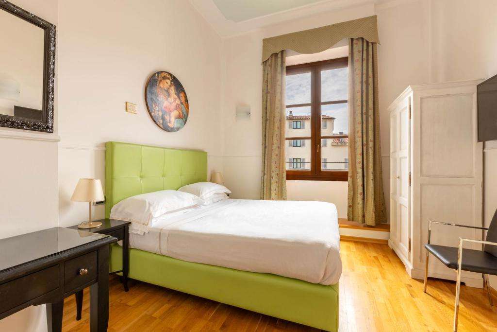 Postel nebo postele na pokoji v ubytování Relais Hotel Centrale "Dimora Storica"