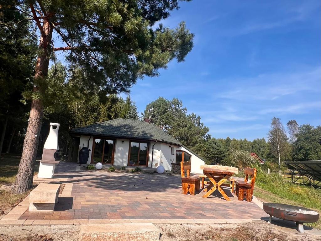 a pavilion with a table and a picnic table at Gajówka Pilica 45A in Łęg Ręczyński