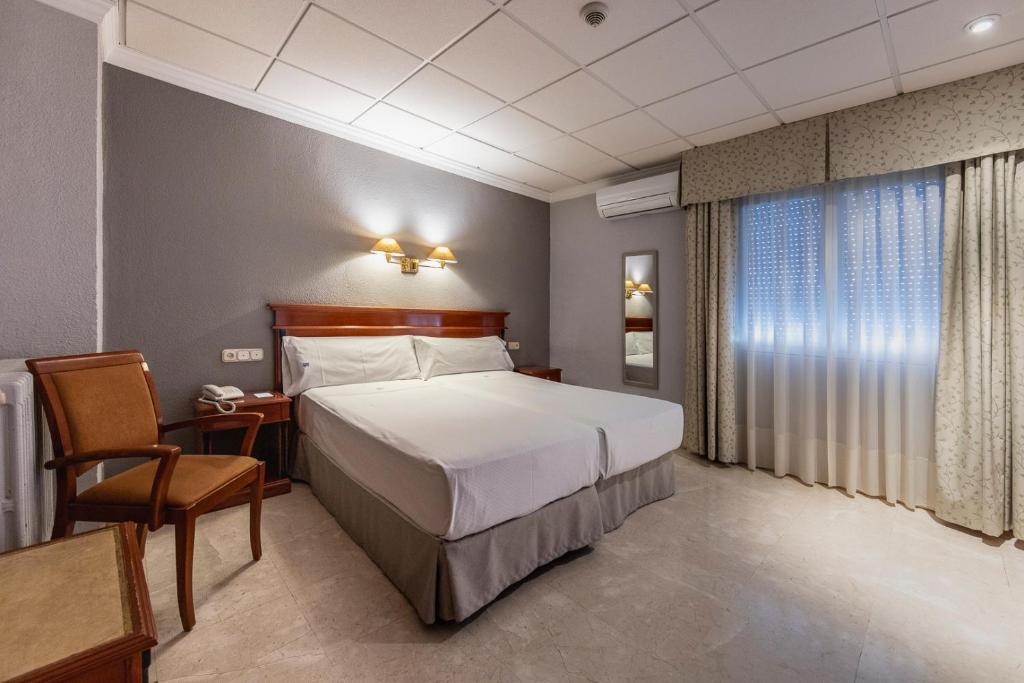 Postel nebo postele na pokoji v ubytování Hotel Sacromonte
