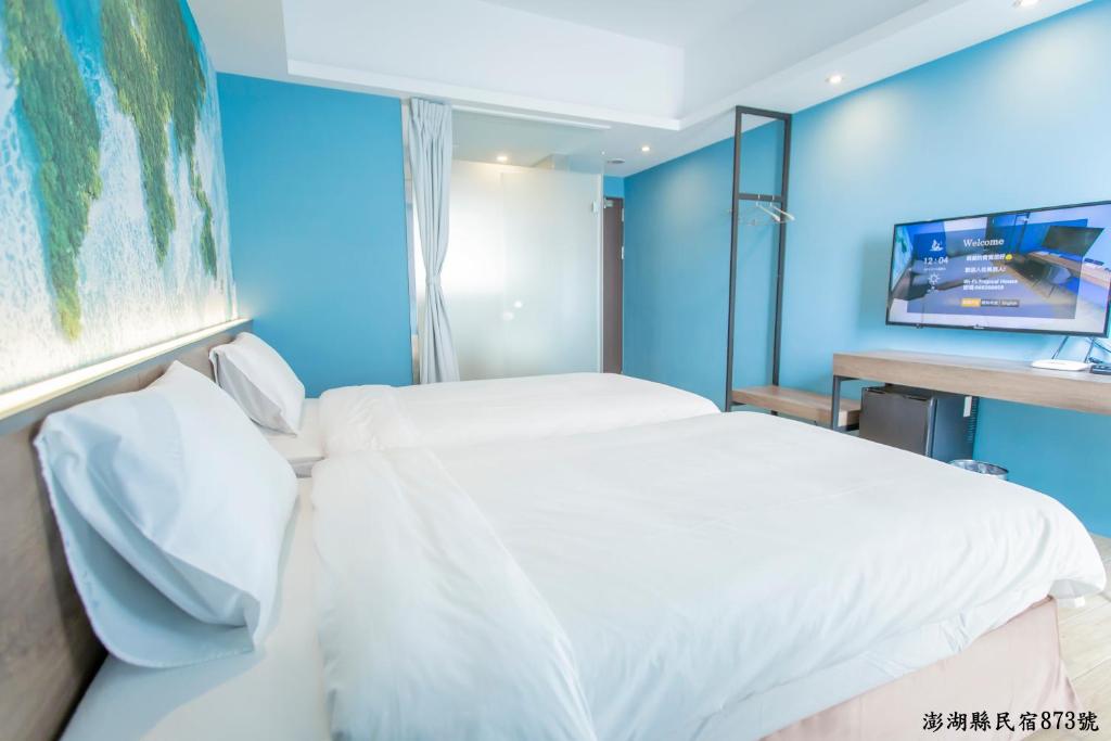 Postel nebo postele na pokoji v ubytování Tropical house Homestay