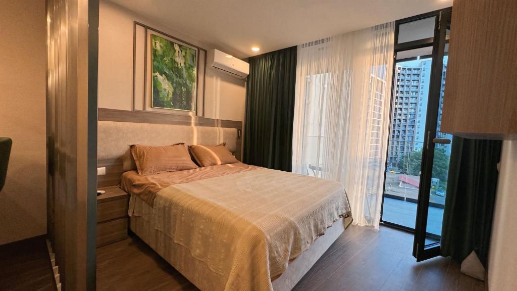 Ένα ή περισσότερα κρεβάτια σε δωμάτιο στο Sea View Apartment in Batumi - Rainbow Residence