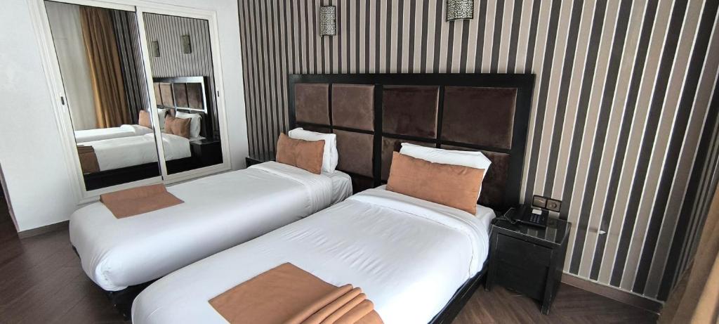 Postel nebo postele na pokoji v ubytování Hotel Swani