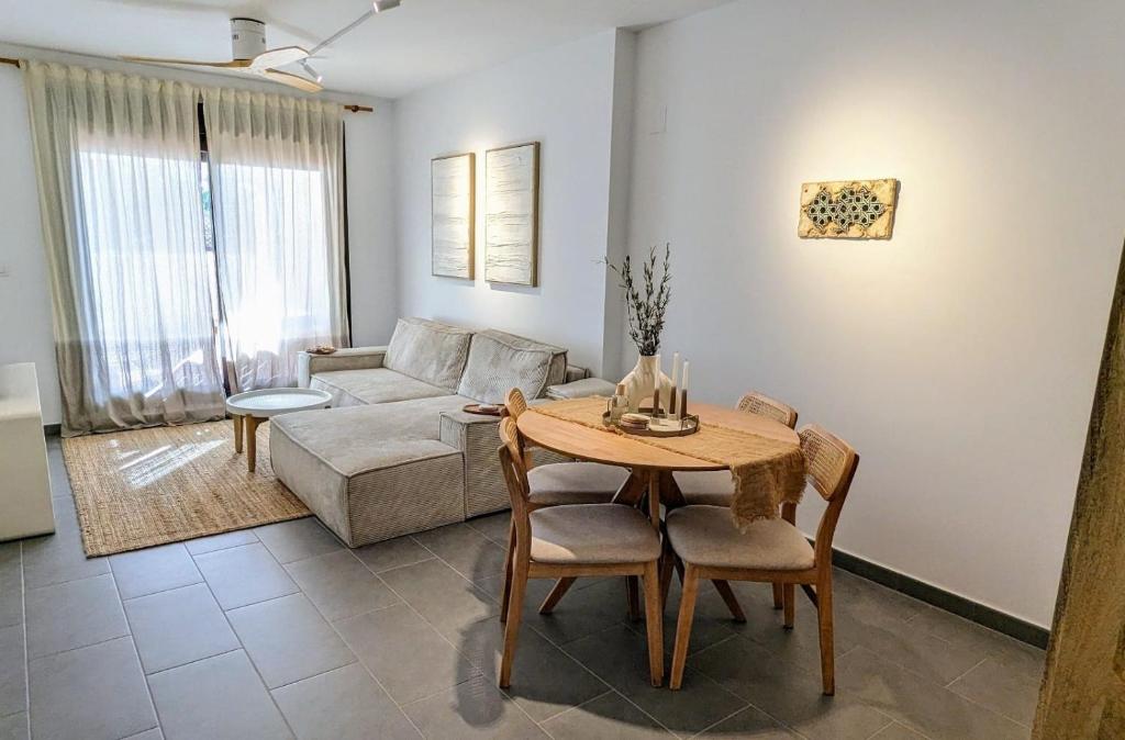a living room with a table and a couch at Sea&Ski Oasis Apartment in Salobreña