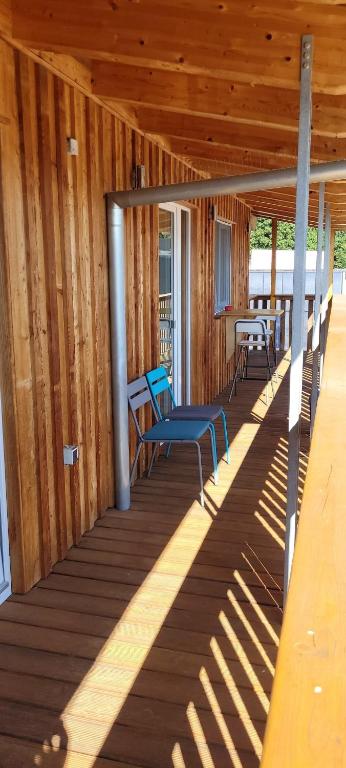 a porch of a cabin with a blue bench on it at Schöne Drei Zimmerwohnung in Ebersbach an der Fils