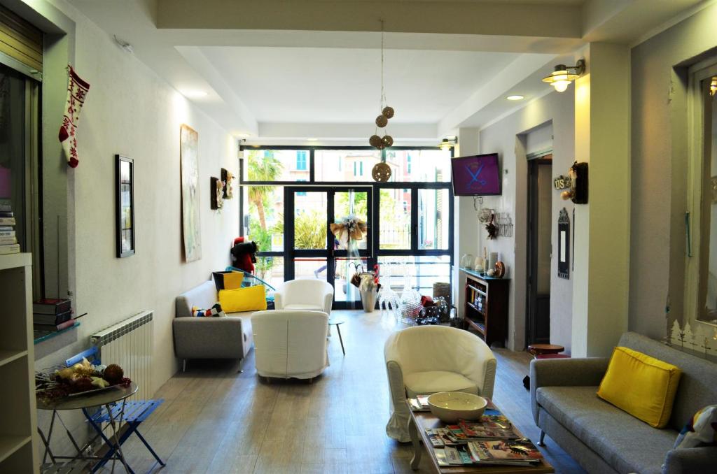 a living room with a person sitting on a couch at Hotel Spot Varazze in Varazze