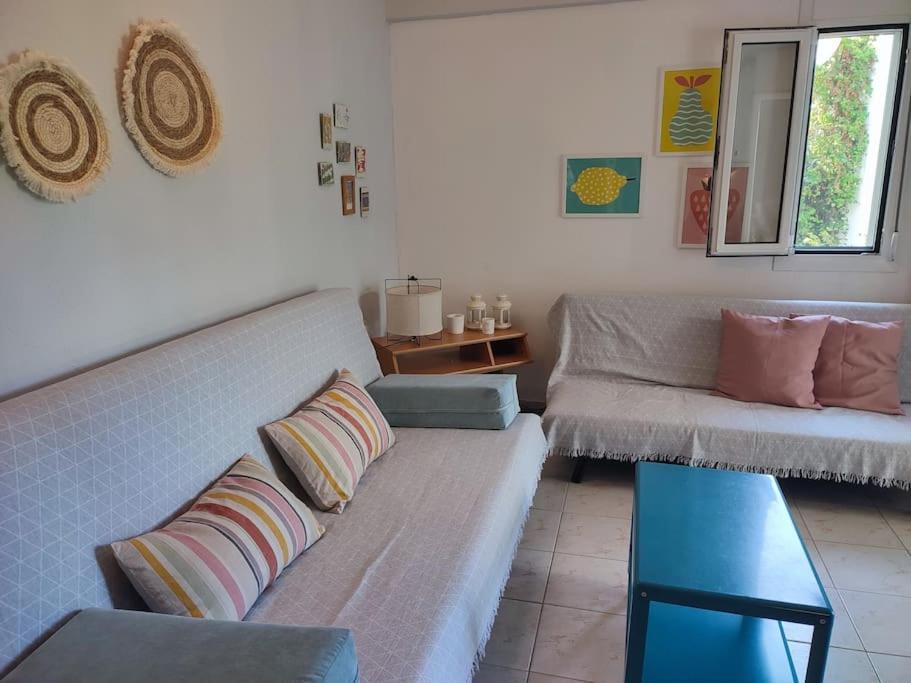 a living room with a couch and a table at Filippos house in Nea Fokaia in Nea Fokea