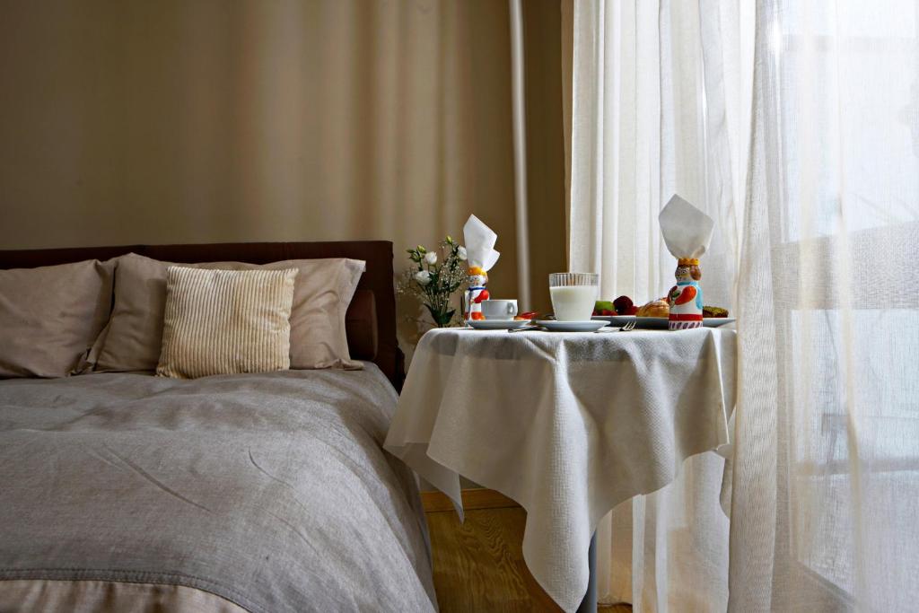 a bedroom with a bed with a table with a table at Venere B&B in Catania