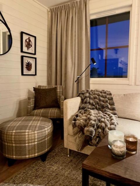 a living room with a couch and a chair and a window at Sälfjällstorget in Sälen