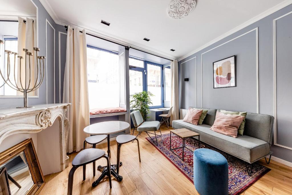 un salon avec un canapé et une cheminée dans l'établissement Suite Notre Dame 1 Bedroom, à Paris