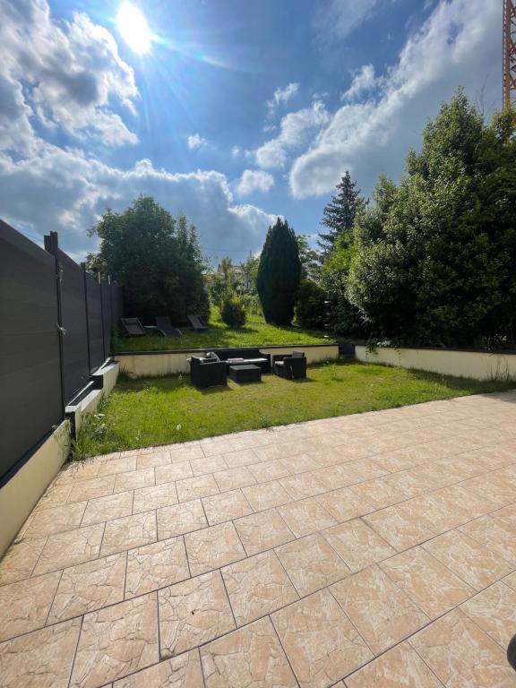 a patio with benches in a backyard at Paris chez jade in Thiais