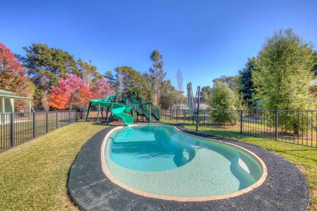 a small pool with a playground in a park at Ashwood Alpine House in Bright