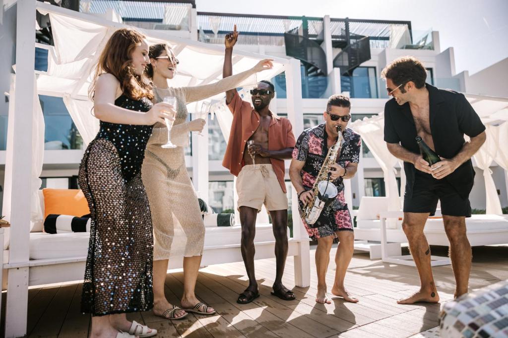 a group of people standing on the deck of a cruise ship at Hard Rock Hotel Ibiza in Playa d'en Bossa