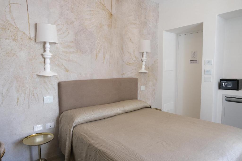 Postel nebo postele na pokoji v ubytování Palazzo Arco Cadura Hotel & Spa