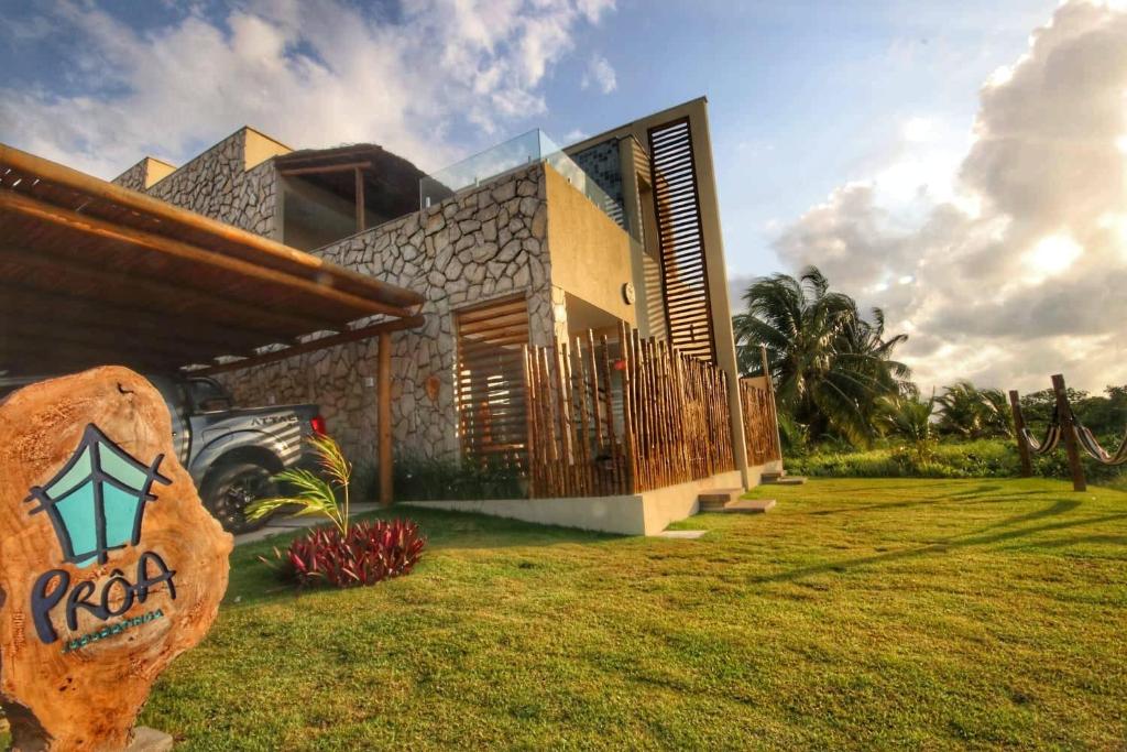 a house with a sign in front of it at Proa Japaratinga in Japaratinga
