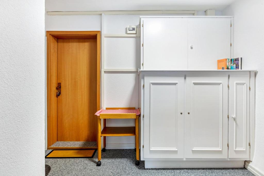 a room with a door and a desk next to a cabinet at Haus Am Bühl in Schönau im Schwarzwald