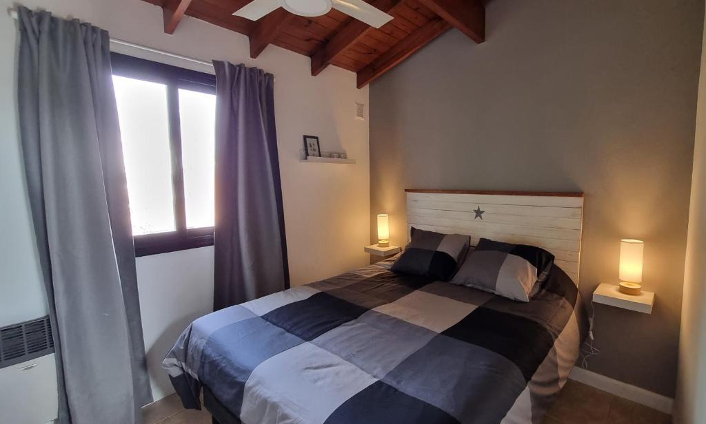 a bedroom with a bed with two lamps and a window at NidoAparte III Lujan Centro-4 Pax-Duplex in Luján
