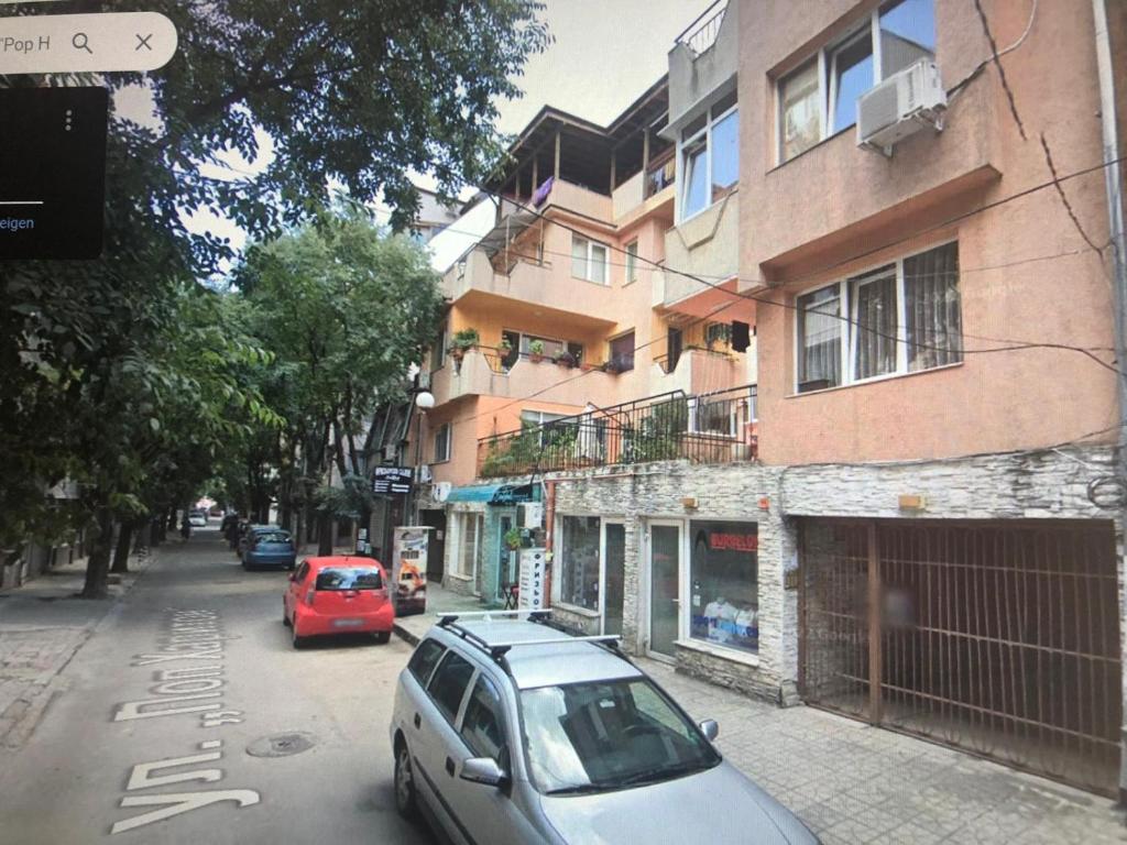 a car parked on a street next to a building at Tanjas City Apartment in Varna City