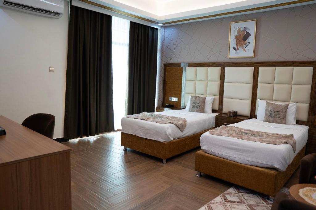 Postel nebo postele na pokoji v ubytování HAMDAAN Hotel