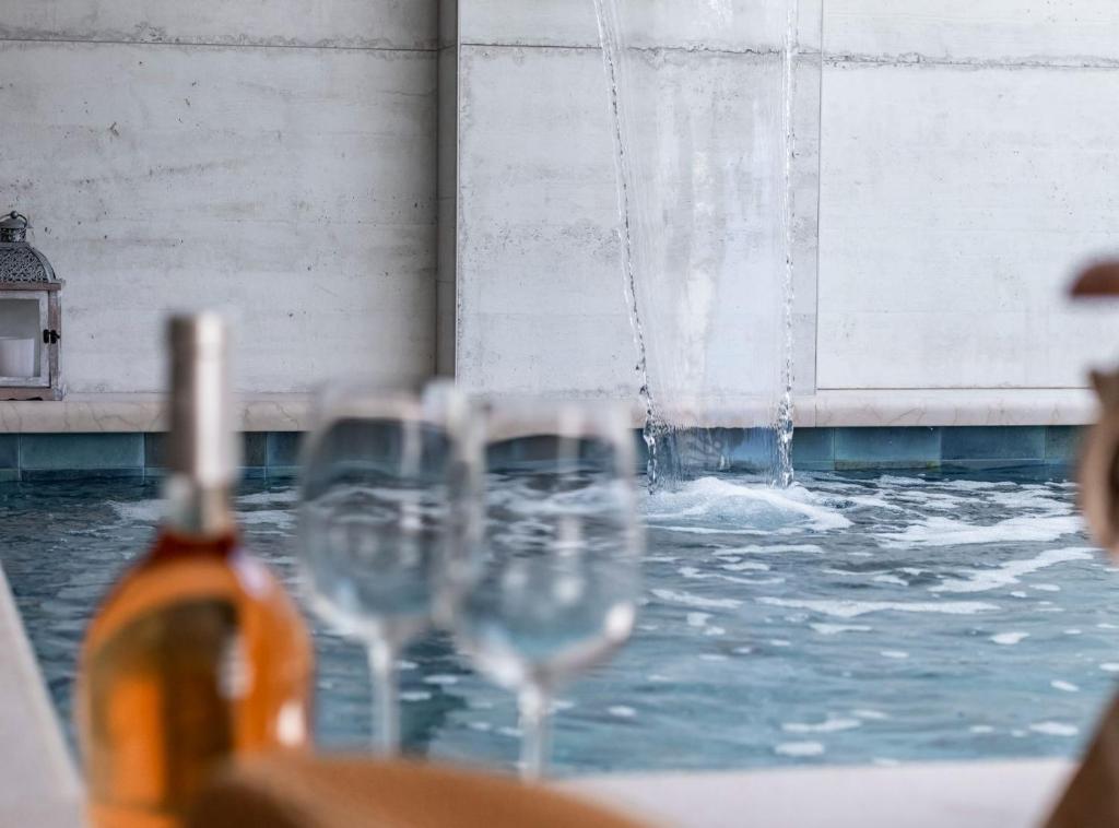 a group of wine glasses in front of a fountain at Luxury Private Spa Apartment with Heated Pool & Sauna and Sea View in Cavtat