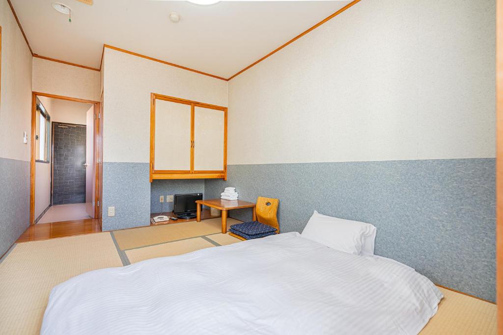 Postel nebo postele na pokoji v ubytování 富士見の宿