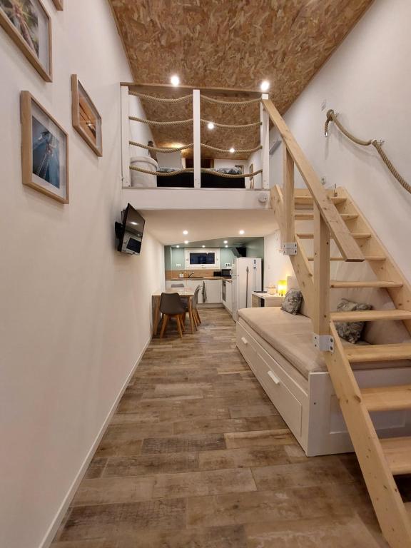 a room with a staircase leading up to a loft at Le Studio de L'Ayguade - Plage à 100 m in Hyères