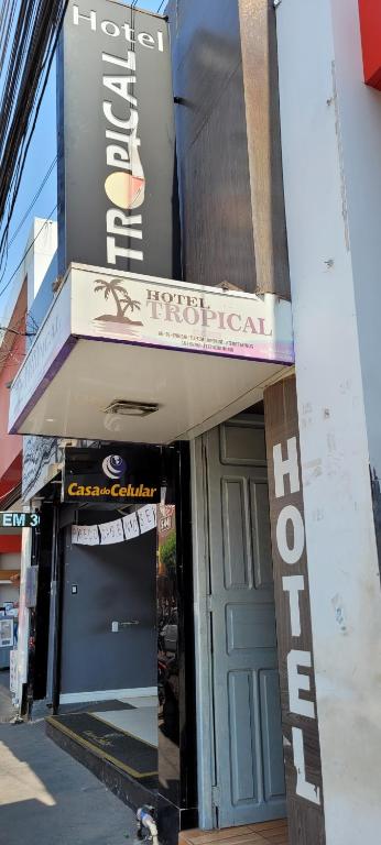 a building with a sign for a hotel at HOTEL TROPICAL in Cuiabá