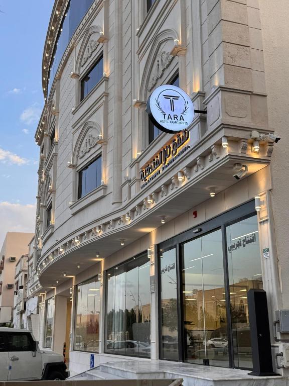 a building with a clock on the side of it at شقق تارا الفندقية in Najran