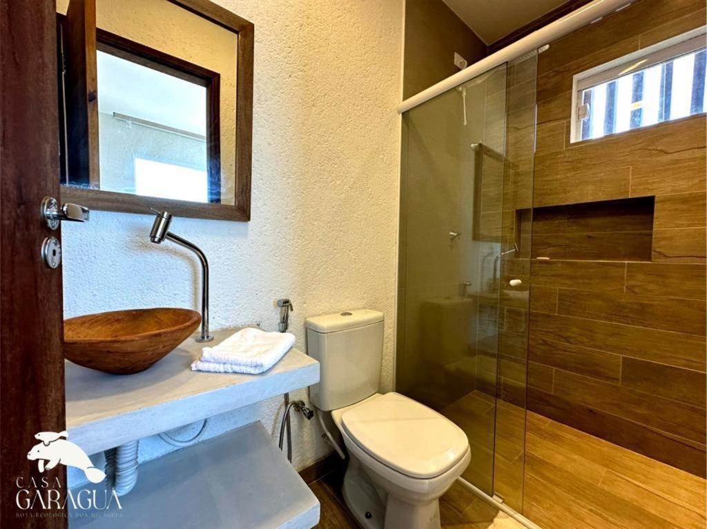 a bathroom with a sink and a toilet and a shower at Casa a 1200m da Praia do Patacho - Casa Garaguá in Pôrto de Pedras