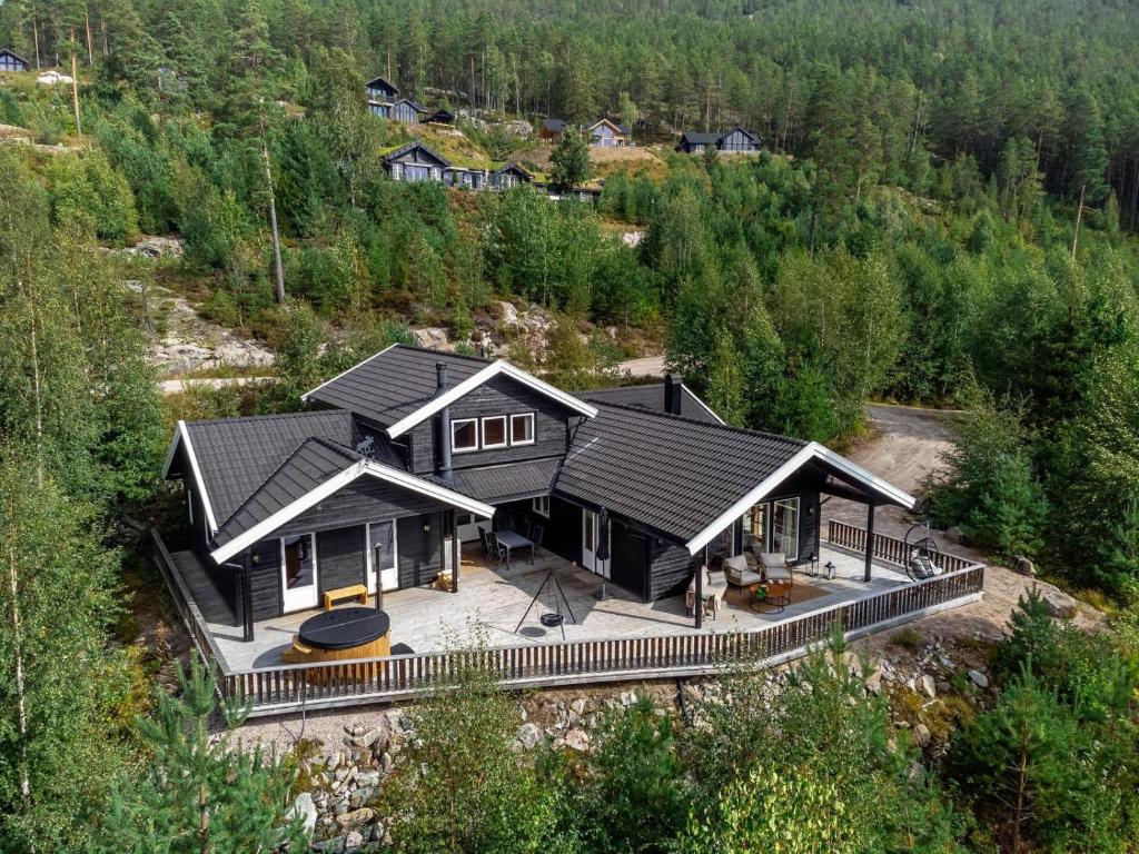 an aerial view of a house with a black roof at Verhøf Hytte - 9p - With Sauna & Hot Tub in Vradal