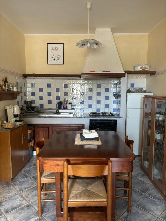 a kitchen with a wooden table and a stove at Casa Vacanze Primavera in Maratea