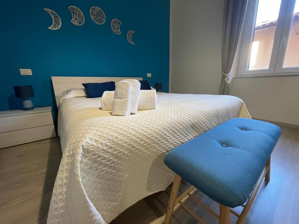 a bedroom with a bed with a blue wall at Luna D'Argento Apartment in Porto Ercole