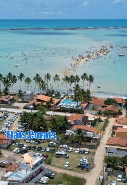 an aerial view of a beach with boats in the water at Flats Corais in Maragogi