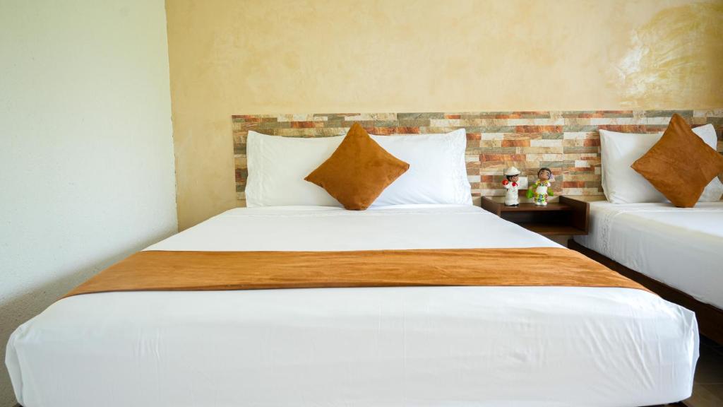 Postel nebo postele na pokoji v ubytování Hotel del Parque