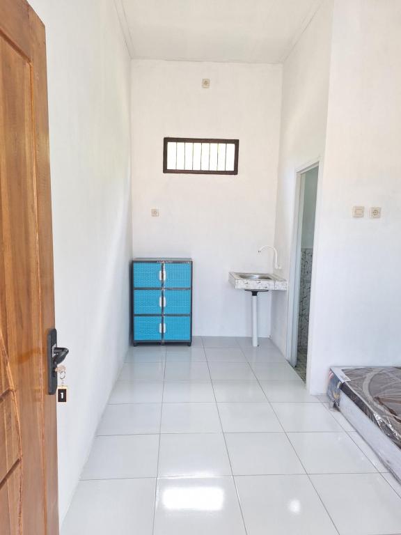 a hallway with a blue cabinet and a sink at Asry Homestay in Sekongkang